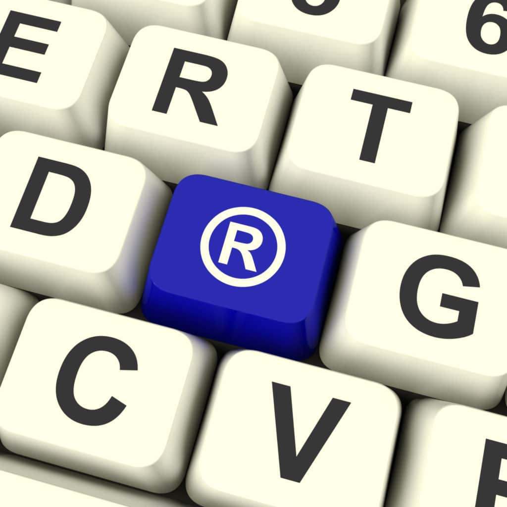 A blue keyboard key has the registered trademark symbol.