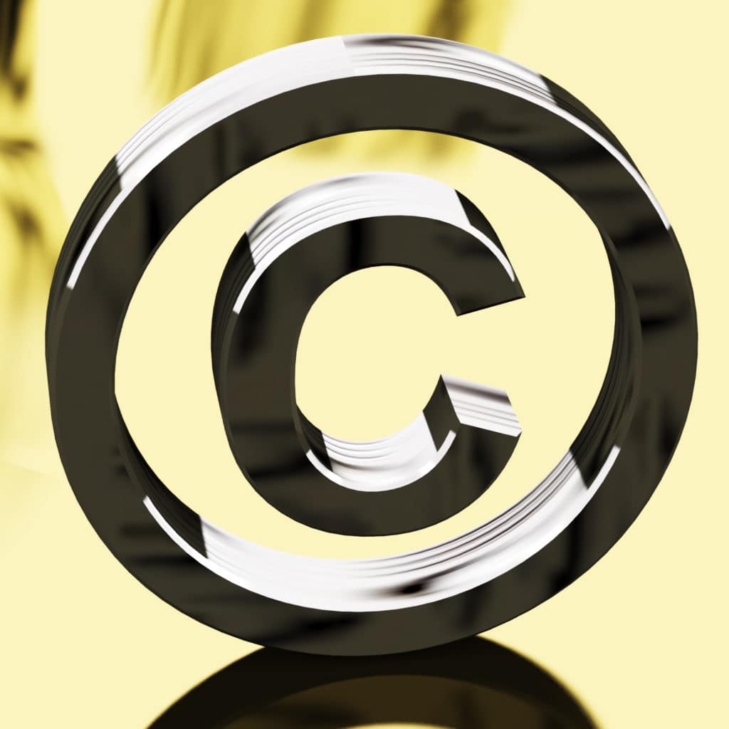 Silver Copyright Sign With Gold Background Representing Patent Protection