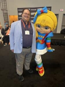 Anthony Verna with a mascot Rainbow Brite at the International Licensing Expo 2023